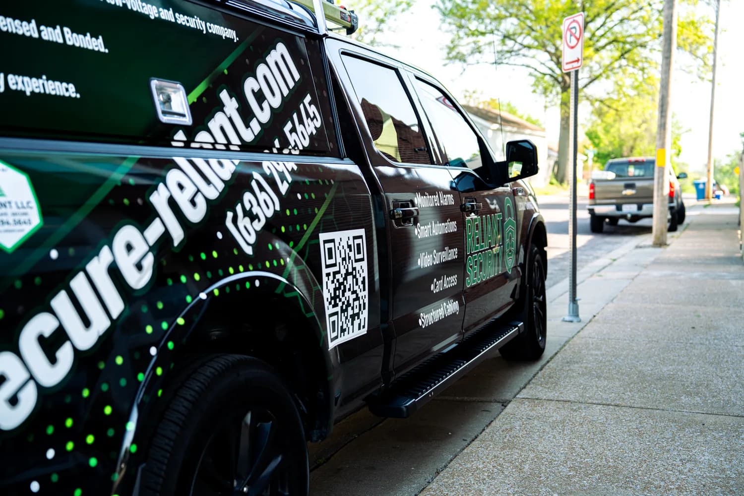 A branded Reliant Security service truck parked on a street in the St. Louis metro.